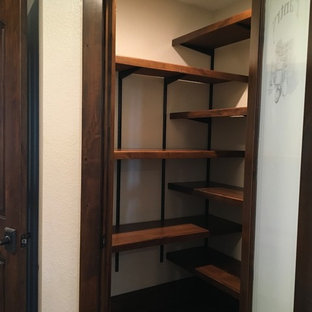 Small craftsman kitchen pantry appliance - Example of a small arts and crafts dark wood floor and brown floor kitchen pantry design in Houston with dark wood cabinets