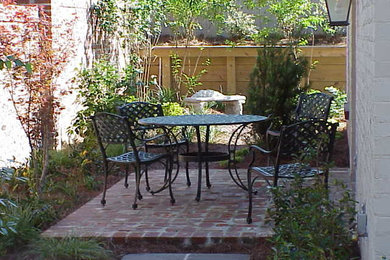 Patio container garden - backyard brick patio container garden idea in Jackson with no cover