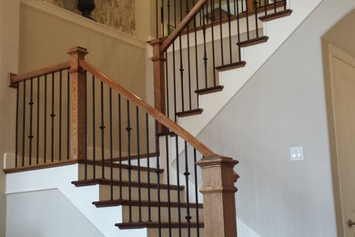 Photo of a mid-sized arts and crafts wood u-shaped staircase in Dallas with painted wood risers.