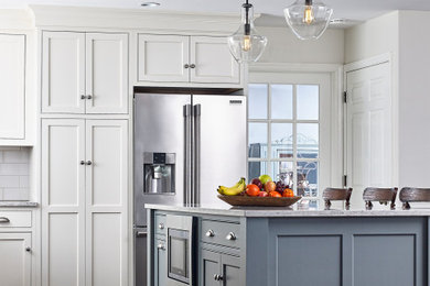 Eat-in kitchen - large contemporary eat-in kitchen idea in Other with a farmhouse sink, beaded inset cabinets, white cabinets, quartzite countertops, white backsplash, subway tile backsplash, stainless steel appliances, an island and gray countertops