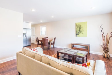 Example of a dark wood floor living room design in New York with beige walls, no fireplace and no tv