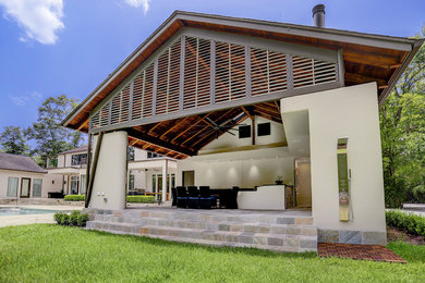 Contemporary beige one-story stucco exterior home idea in Houston with a shingle roof