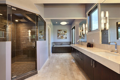 Photo of a large contemporary master bathroom in Denver with an undermount sink, flat-panel cabinets, dark wood cabinets, marble benchtops, an undermount tub, a corner shower, gray tile, porcelain tile, purple walls and travertine floors.