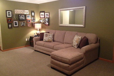 Basement - mid-sized transitional underground carpeted basement idea in Cleveland with green walls