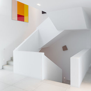 Photo of an expansive contemporary tiled u-shaped staircase in Cologne with tiled risers.