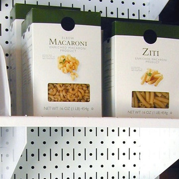 A Wall Control pegboard shelve being used to organize food in a pantry