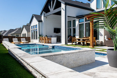 Pool - mid-sized backyard stone and rectangular pool idea in Dallas with a bbq area
