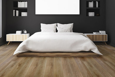 Example of a minimalist vinyl floor and brown floor bedroom design in Montreal