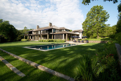 Design ideas for a traditional backyard retaining wall landscape in New York.