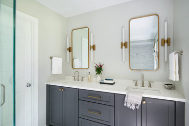 Example of a large transitional master white tile and porcelain tile porcelain tile, white floor and double-sink bathroom design in DC Metro with shaker cabinets, gray cabinets, a two-piece toilet, white walls, an undermount sink, quartz countertops, a hinged shower door, white countertops, a niche and a built-in vanity