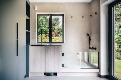 Photo of a medium sized modern utility room in Surrey with flat-panel cabinets, ceramic splashback and vinyl flooring.