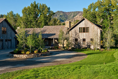 Large cottage brown two-story wood exterior home photo in Boise with a shingle roof