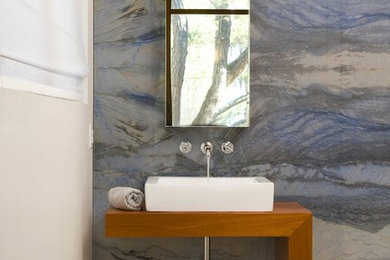 Contemporary bathroom in DC Metro with wood benchtops, blue tile, stone slab and brown benchtops.