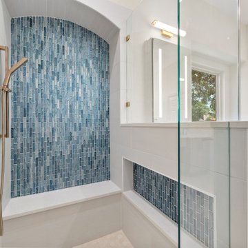 Close-Up View of Blue Glass Mosaic Shower Accent Wall with Built-In Niche and Br