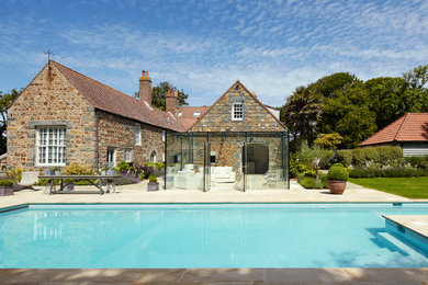 This is an example of a country home design in Channel Islands.