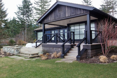 Example of a mid-sized arts and crafts brown two-story wood gable roof design in Vancouver