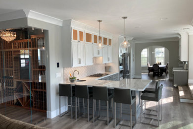 Example of a transitional single-wall kitchen design in San Luis Obispo with shaker cabinets, gray cabinets, solid surface countertops, gray backsplash, porcelain backsplash and stainless steel appliances