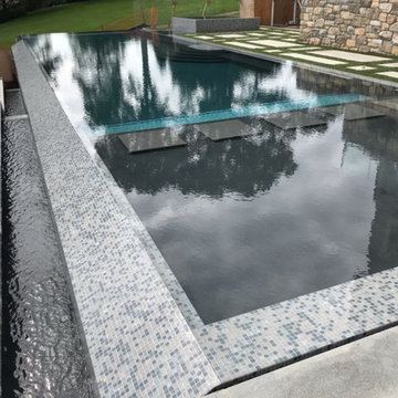 vanishing edge glass wall pool + raised perimeter overflow spa