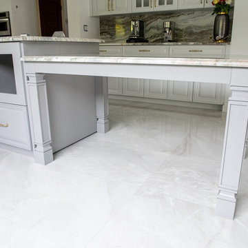 Transitional Kitchen Done in a 2 Tone Color With Integrated Dining Table