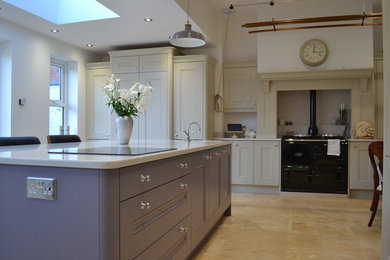 Photo of a large traditional separate kitchen in Manchester with a single-bowl sink, beaded inset cabinets, purple cabinets, quartzite benchtops, black appliances, travertine floors, with island and beige floor.