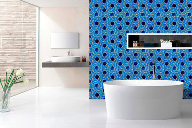 This is an example of a mid-sized modern master bathroom in Gold Coast - Tweed with blue walls, mosaic tile, beaded inset cabinets, white cabinets, a drop-in tub, a corner shower, a one-piece toilet, green tile, porcelain floors, a drop-in sink, solid surface benchtops, white floor, an open shower and grey benchtops.