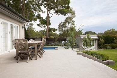 Inspiration for a large traditional backyard full sun formal garden for spring in Sydney with natural stone pavers.
