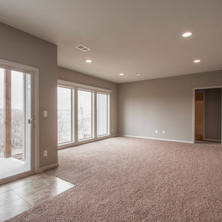 Large classic walk-out basement in Kansas City with grey walls, carpet and pink floors.