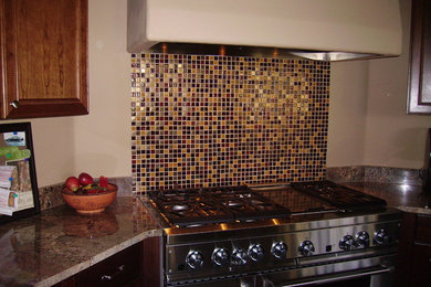 Kitchen - kitchen idea in Denver with beaded inset cabinets, medium tone wood cabinets, granite countertops, multicolored backsplash, mosaic tile backsplash and stainless steel appliances