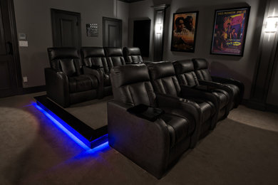 Example of a transitional enclosed carpeted and beige floor home theater design in Dallas with gray walls