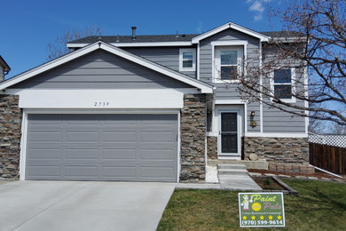 Mid-sized traditional gray two-story wood house exterior idea in Denver with a shingle roof and a gray roof