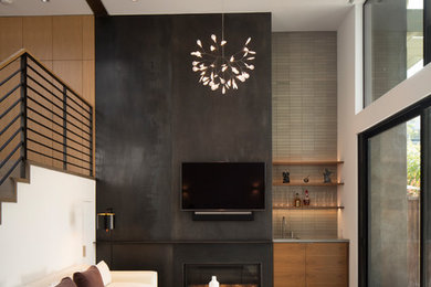 This is an example of a midcentury family room in San Francisco with a home bar, concrete floors, a metal fireplace surround, a wall-mounted tv and a ribbon fireplace.