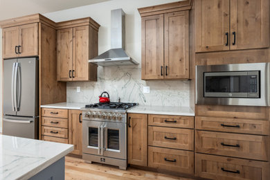 Inspiration for a mid-sized 1950s single-wall medium tone wood floor open concept kitchen remodel in Boise with recessed-panel cabinets, medium tone wood cabinets, quartz countertops, multicolored backsplash, quartz backsplash, an island and multicolored countertops