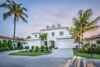 Coastal white two-story house exterior idea in Miami with a hip roof