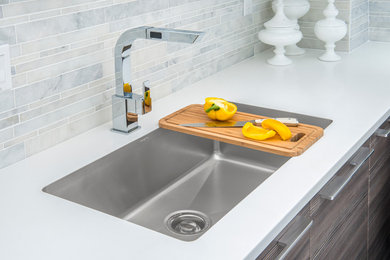 Trendy u-shaped kitchen photo in Miami with an undermount sink, flat-panel cabinets, dark wood cabinets, white backsplash, porcelain backsplash, stainless steel appliances and no island