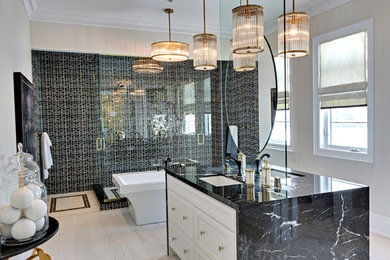 Inspiration for a large traditional master bathroom in Toronto with white cabinets, a freestanding tub, a double shower, an undermount sink, marble benchtops, a hinged shower door, recessed-panel cabinets, black tile, mosaic tile, grey walls, light hardwood floors and beige floor.