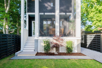 Mid-sized minimalist stone front porch idea in Charleston