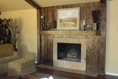 Inspiration for a timeless medium tone wood floor family room remodel in Austin with a standard fireplace and a wood fireplace surround