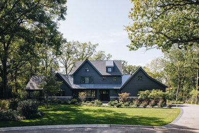 Inspiration for a large arts and crafts two-storey grey house exterior in Chicago with a grey roof.