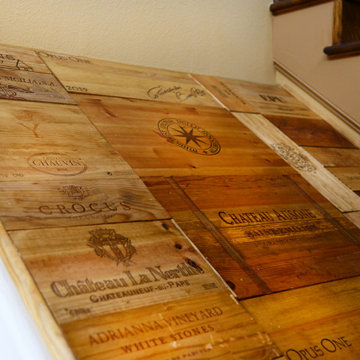 Art piece over ceiling in stairway nook using wine crates