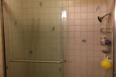 Mid-sized trendy kids' white tile and ceramic tile slate floor and gray floor bathroom photo in Seattle with recessed-panel cabinets, brown cabinets, a one-piece toilet, blue walls, an integrated sink and quartz countertops