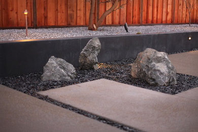 Inspiration for a mid-century modern drought-tolerant and rock backyard gravel and wood fence landscaping in San Francisco.