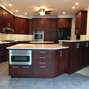 Bright kitchen with dark cabinets and white countertops & Sharp drawer microwave