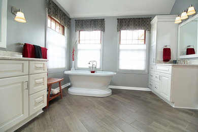 Freestanding bathtub - large transitional master gray tile and ceramic tile ceramic tile and gray floor freestanding bathtub idea in Other with raised-panel cabinets, white cabinets, a two-piece toilet, gray walls, an undermount sink, quartz countertops and a hinged shower door