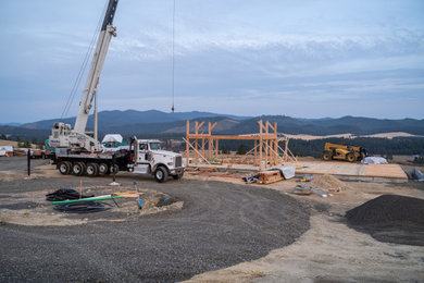 Example of a large mountain style concrete fiberboard and board and batten house exterior design in Other with a metal roof