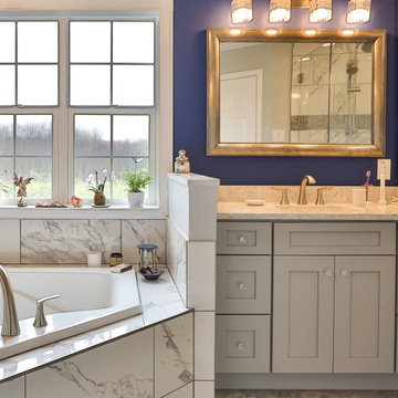 Master bathroom remodel in Poquoson with corner bathtub & marble lined tiles