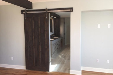 Inspiration for a mid-sized rustic medium tone wood floor and brown floor hallway remodel in Boise with gray walls