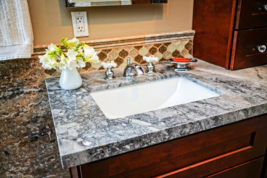 Mid-sized transitional 3/4 green tile and glass tile bathroom photo in San Diego with an undermount sink, recessed-panel cabinets, dark wood cabinets, quartzite countertops, a one-piece toilet and beige walls