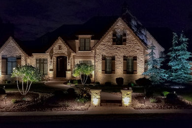 This is an example of a large transitional full sun front yard stone landscaping in Kansas City for summer.