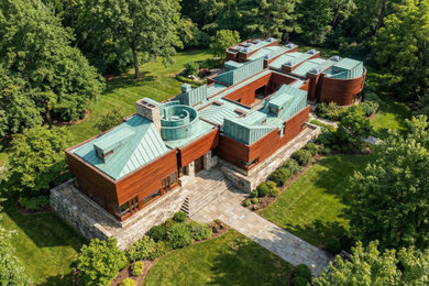 Huge contemporary brown one-story wood and board and batten house exterior idea with a metal roof and a blue roof