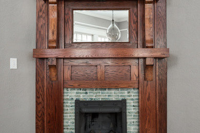 Small arts and crafts open concept light wood floor living room library photo in Atlanta with gray walls, a corner fireplace, a tile fireplace and no tv